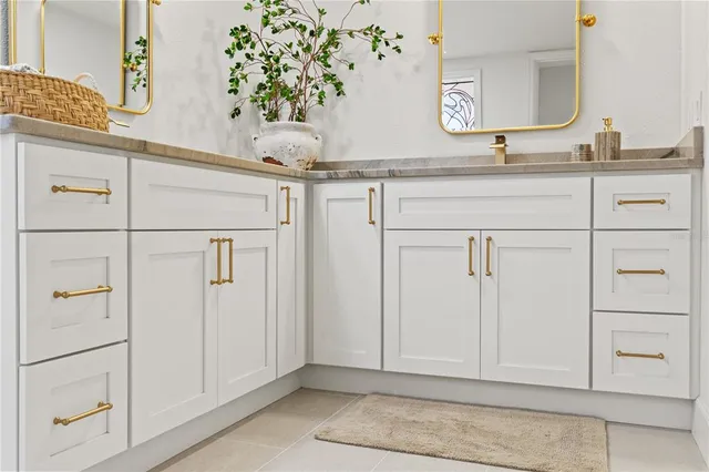 a spacious bathroom with a granite countertop sink a mirror and a