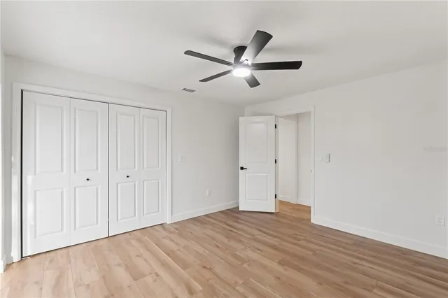 a bathroom with white cabinets and a sink