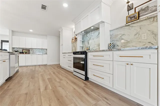 a kitchen with stainless steel appliances a refrigerator sink and cabinets