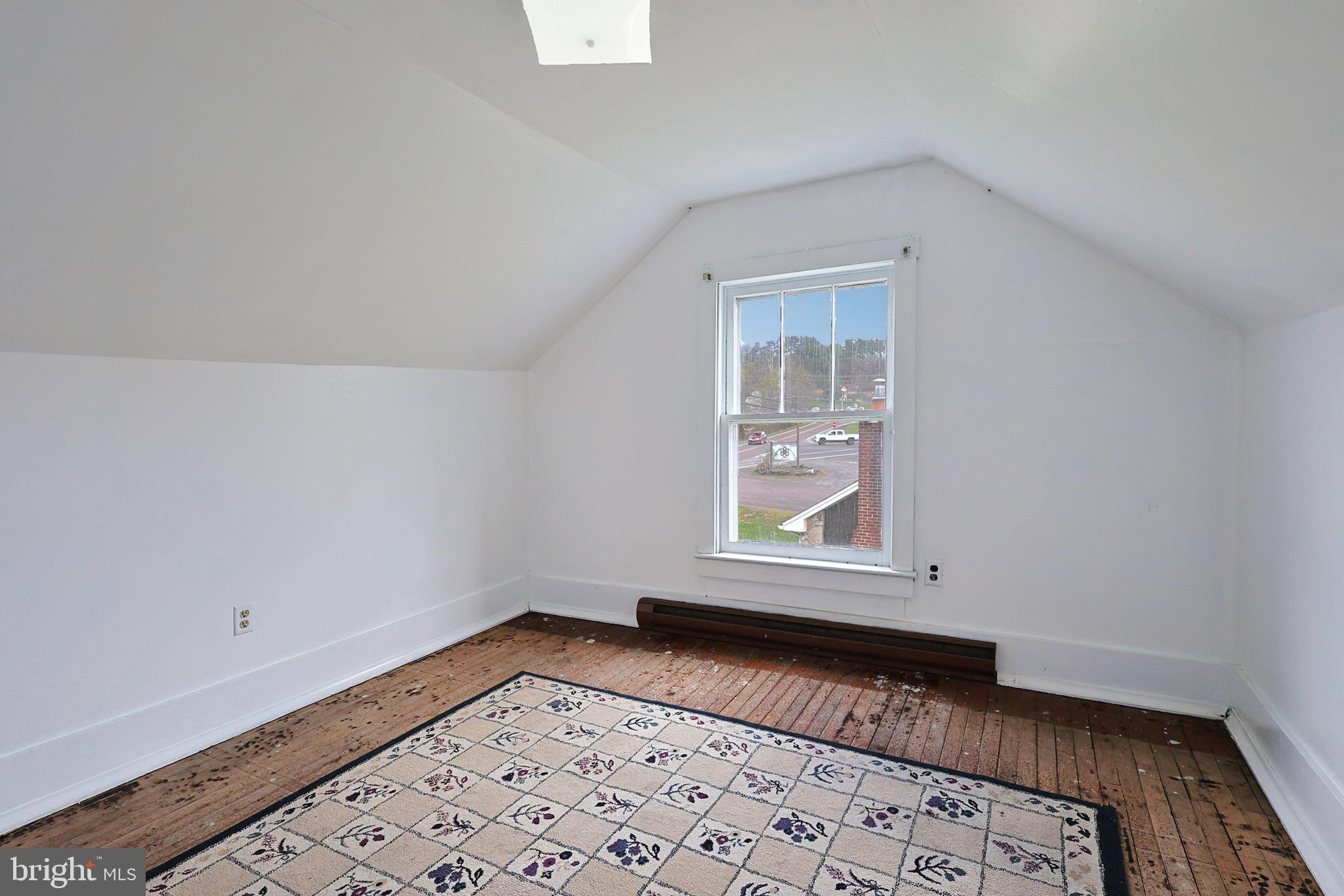 159 Rocket Center Road Keyser, WV 26726 - Photo 37 of 64 an empty room with wooden floor and windows