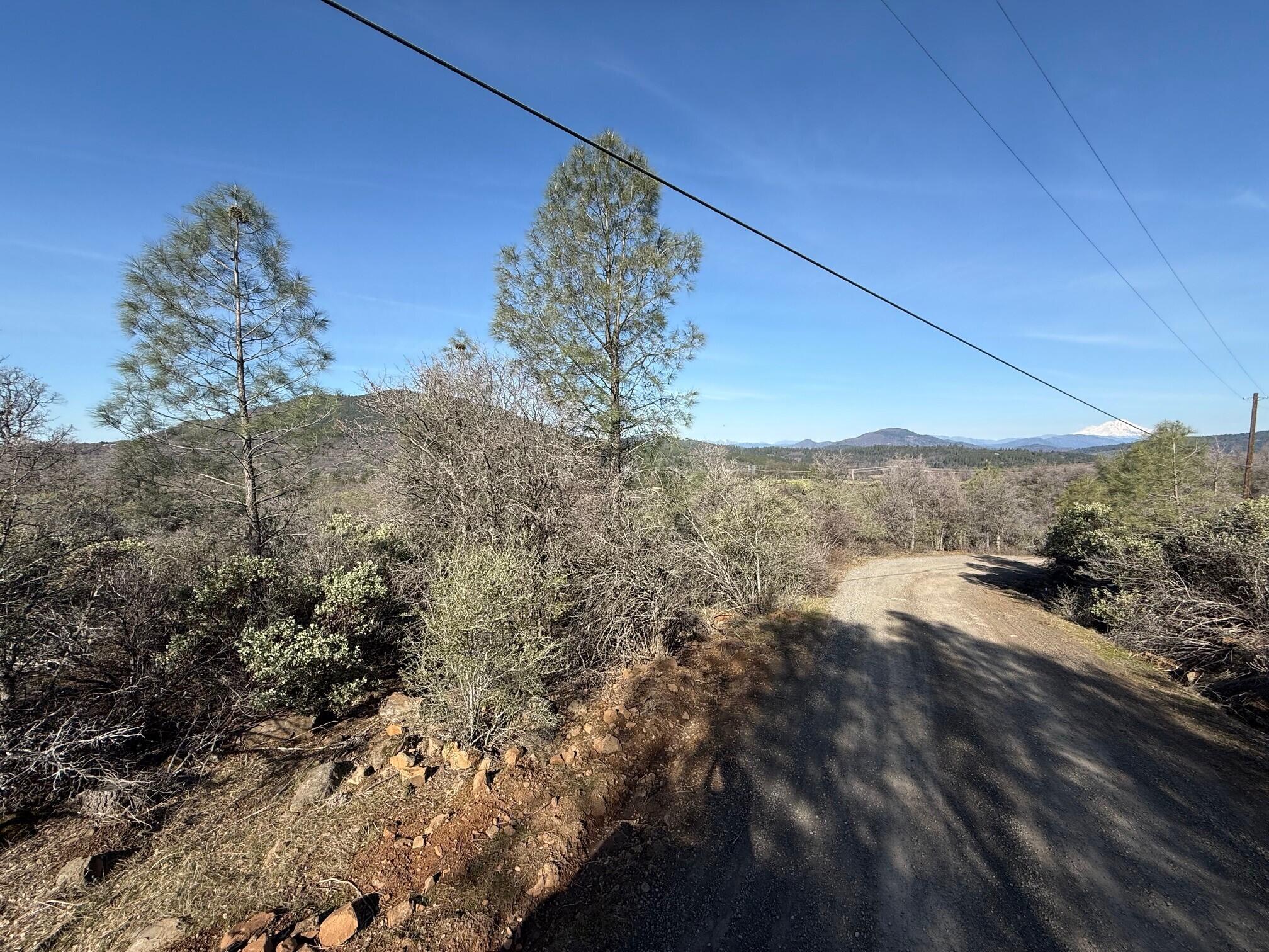 Ranch Road Round Mountain, CA 96084 - Photo 5 of 13 a view of a yard with a mountain
