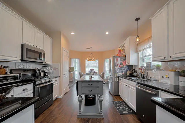 a kitchen with stainless steel appliances a stove sink and cabinets