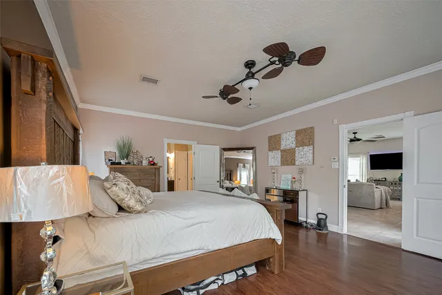 a bedroom with a large bed and a chandelier