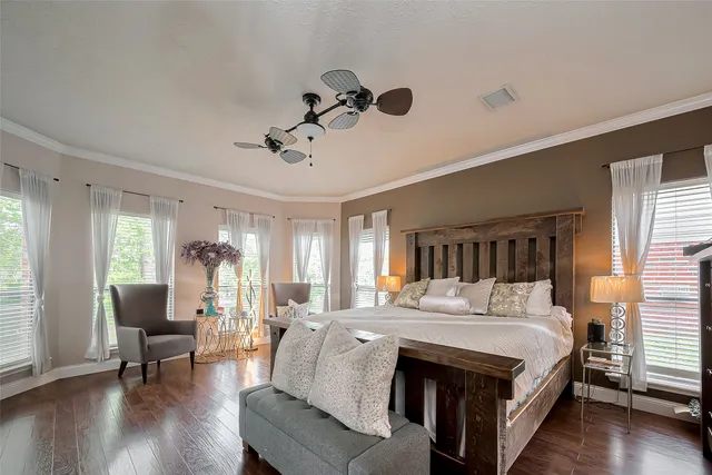 a spacious bedroom with a bed a couch and a window