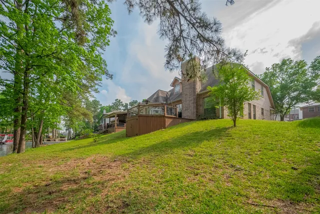 a view of yard with swimming pool and green space