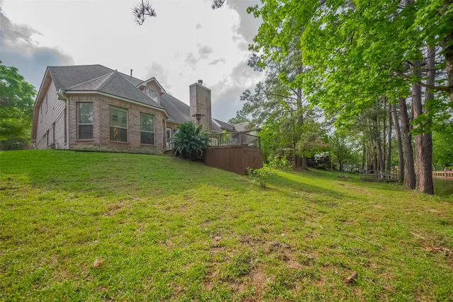a view of a big room with a big yard and large trees