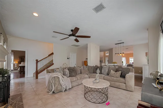a living room with furniture and a chandelier