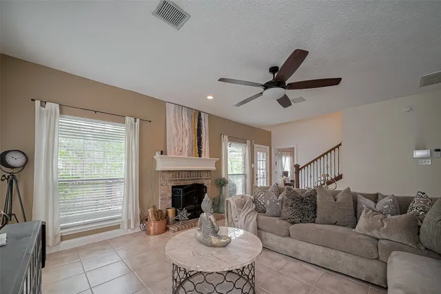 a living room with furniture a fireplace and a table