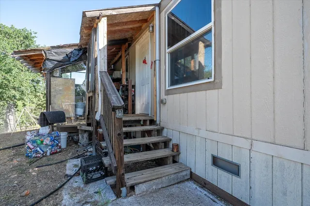 a living room with furniture and a refrigerator