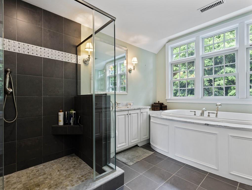 38 Kenilworth Road Wellesley, MA 02482 - Photo 22 of 36 a bathroom with a double vanity sink a toilet and shower