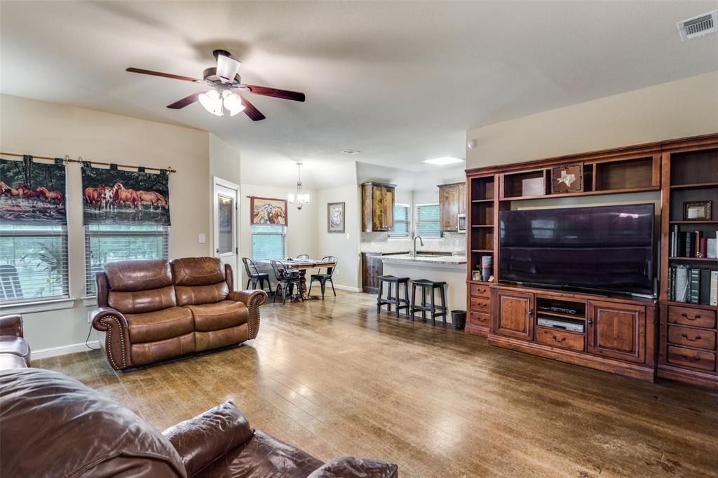 129 Ronnie Lane Weatherford, TX 76088 - Photo 11 of 36 a living room with furniture and a flat screen tv