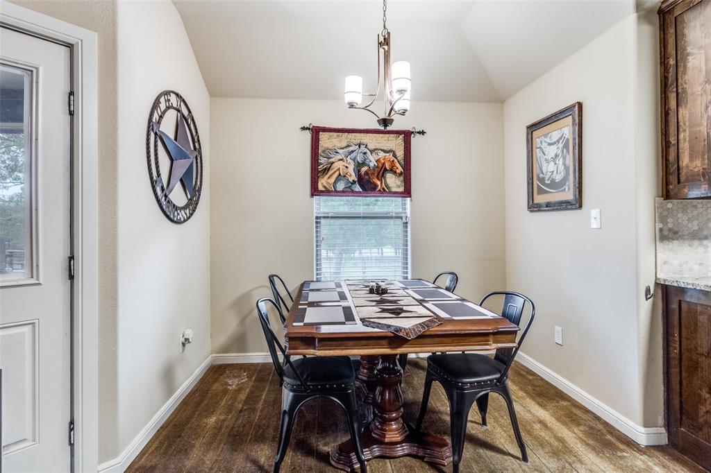 129 Ronnie Lane Weatherford, TX 76088 - Photo 12 of 36 a view of a dining room with furniture wooden floor and a chandelier
