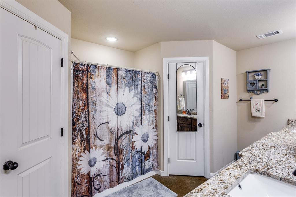 129 Ronnie Lane Weatherford, TX 76088 - Photo 21 of 36 a bedroom with a bed and a bathroom