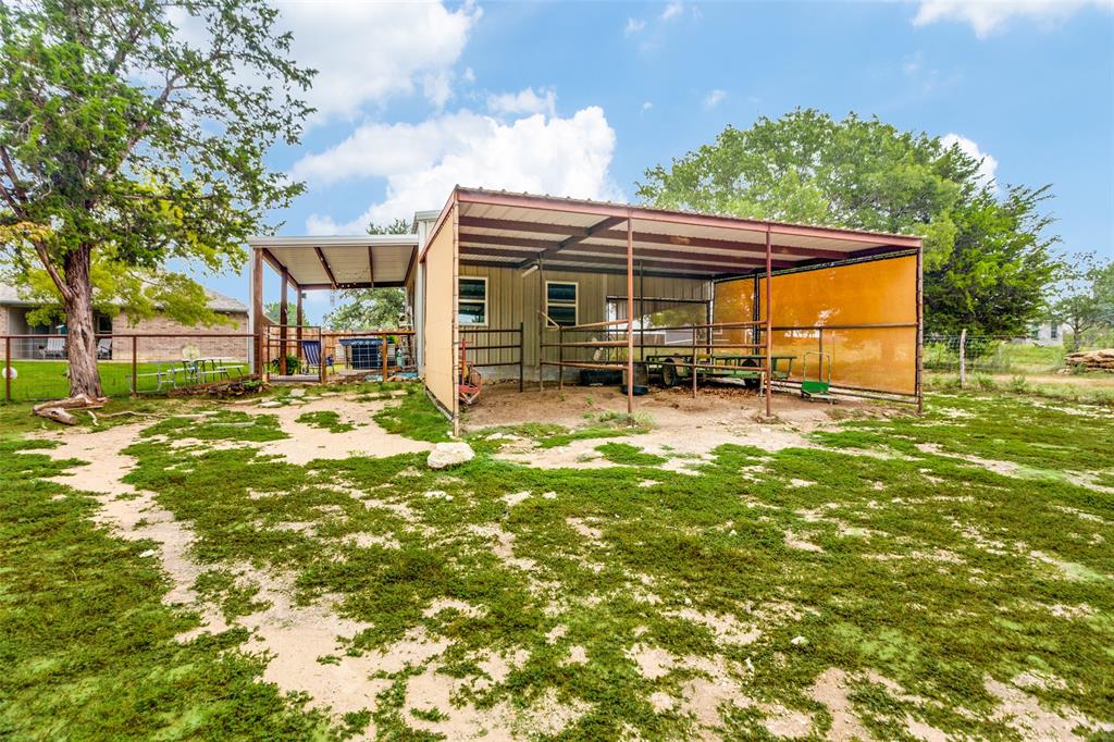129 Ronnie Lane Weatherford, TX 76088 - Photo 30 of 36 a view of backyard with a garden and outdoor seating