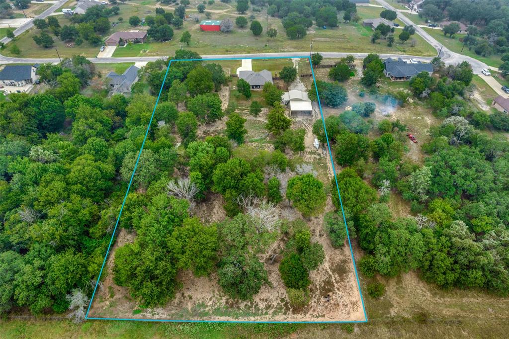 129 Ronnie Lane Weatherford, TX 76088 - Photo 34 of 36 an aerial view of residential houses with outdoor space and trees all around