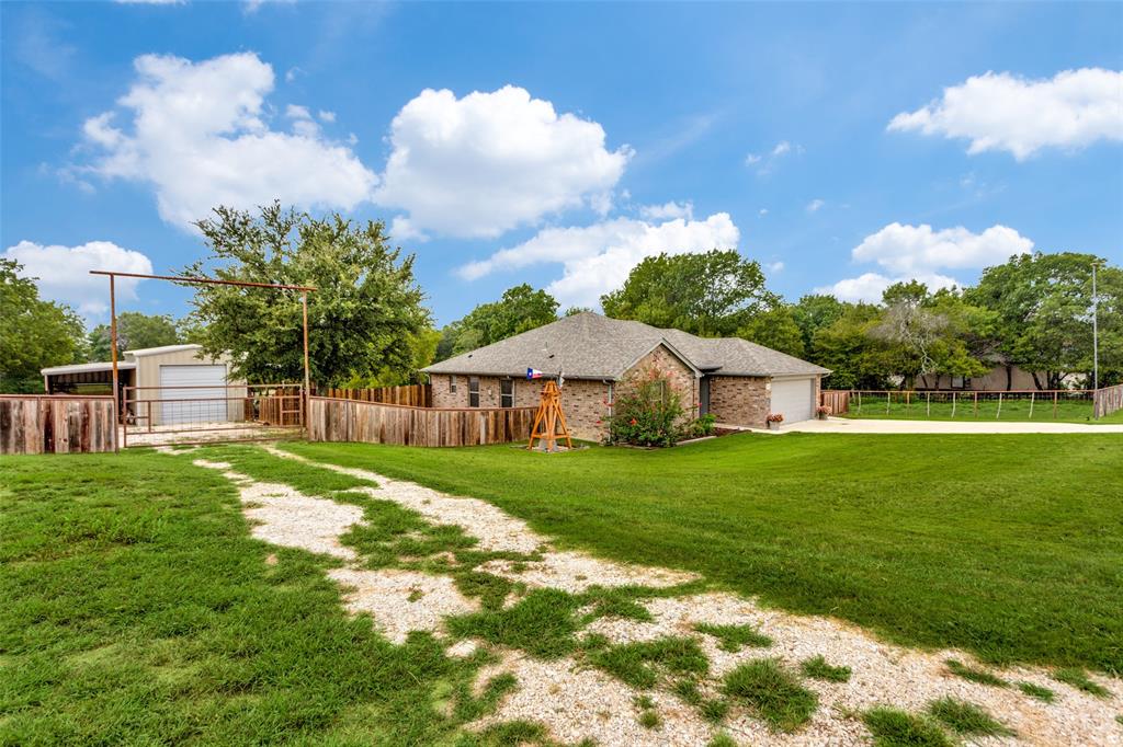 129 Ronnie Lane Weatherford, TX 76088 - Photo 8 of 36 a view of a big house with a big yard and large trees