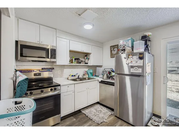 a kitchen with a refrigerator stove and sink