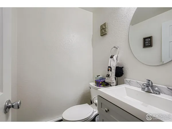 a bathroom with a sink vanity mirror and toilet