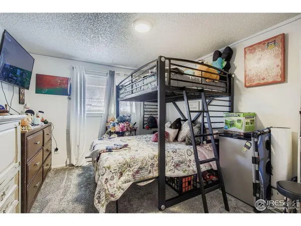 a view of a dining room with furniture and a chandelier