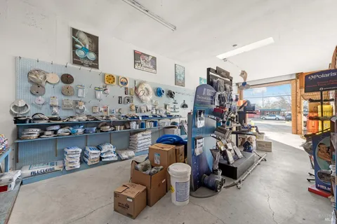 a dining room with furniture a chandelier and kitchen view