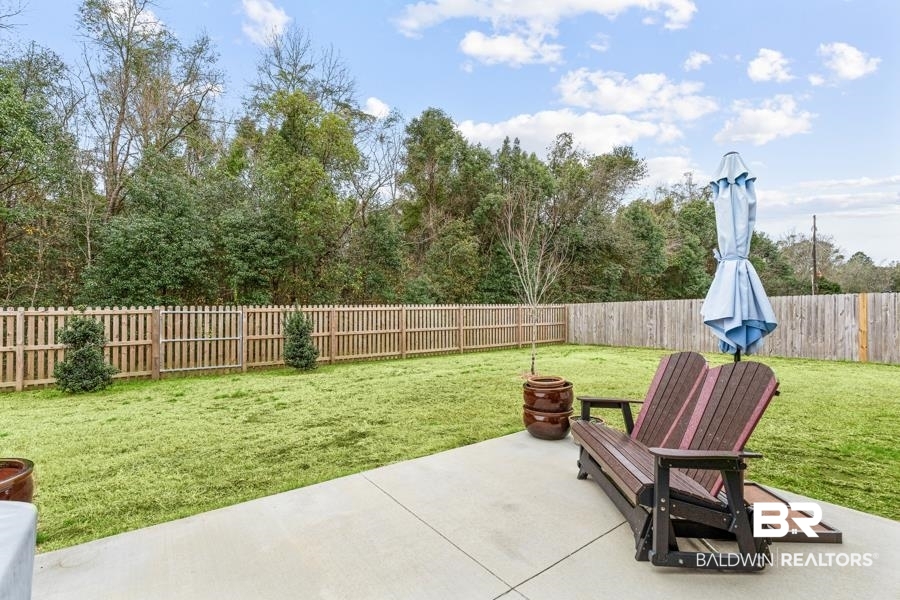 697 Calibre Street Fairhope, AL 36532 - Photo 18 of 18 Fenced backyard with a patio area