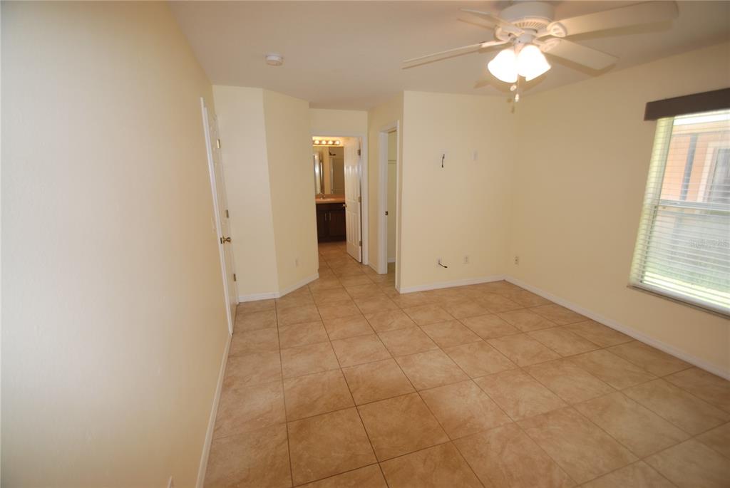217 Robin Road Davenport, FL 33896 - Photo 12 of 27 an empty room with windows and fan