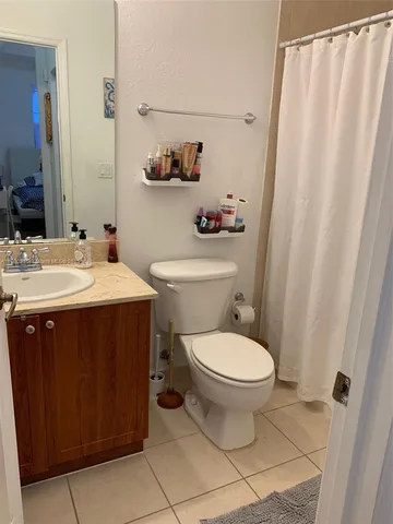 a bathroom with a sink toilet and a mirror