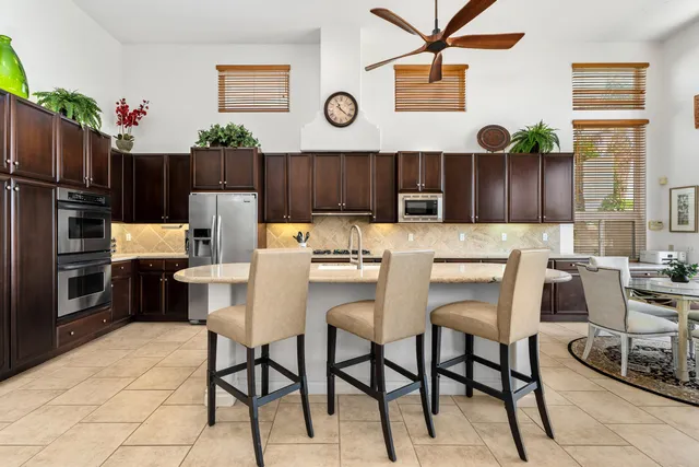 a kitchen with granite countertop a refrigerator cabinets and wooden floor