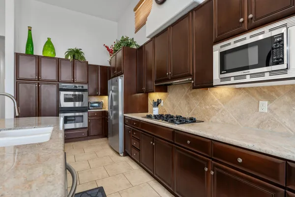 a kitchen with stainless steel appliances and wooden cabinets