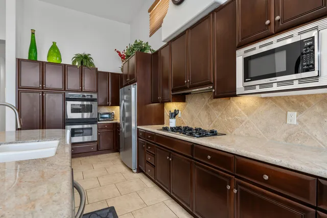 a kitchen with stainless steel appliances and wooden cabinets