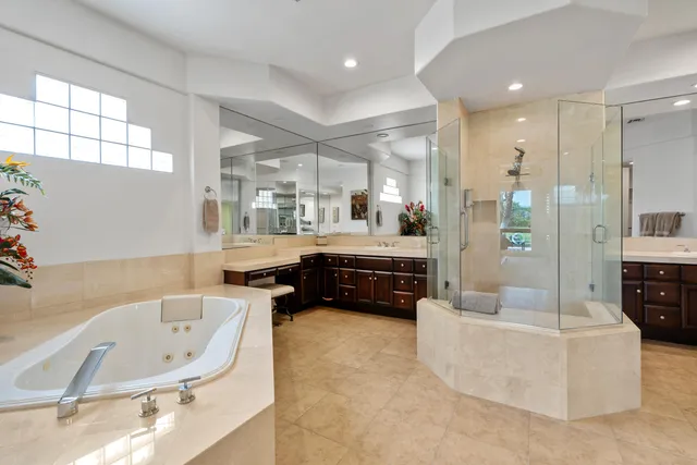 a large white kitchen with a large window