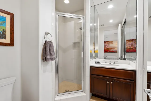 a bathroom with a shower sink and mirror