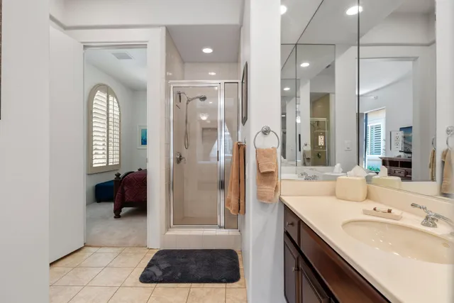 a bathroom with a tub a sink and a large mirror