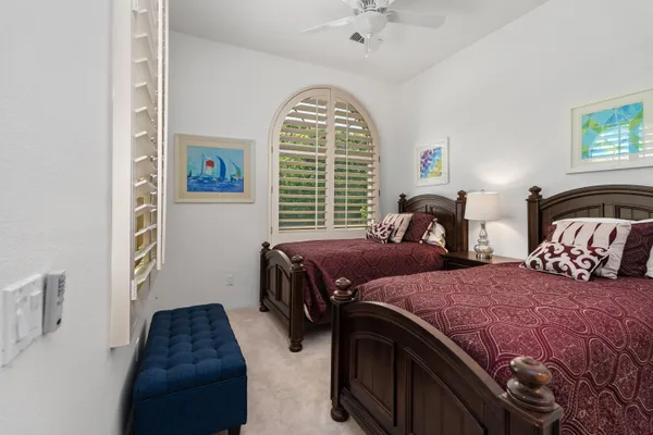a bedroom with two beds and a window