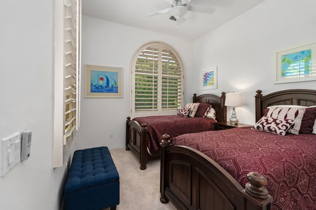 a bedroom with two beds and a window