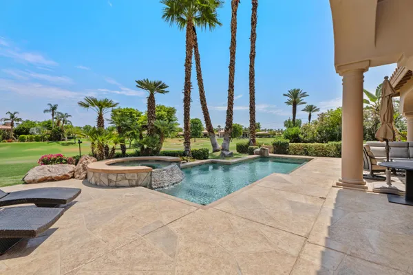 a view of swimming pool with a table and chairs