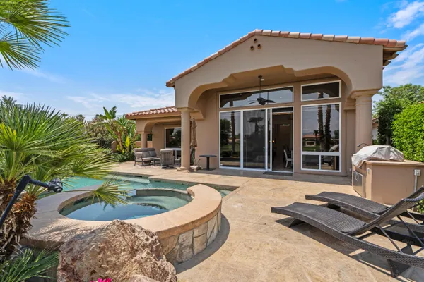 a view of a house with swimming pool and sitting area