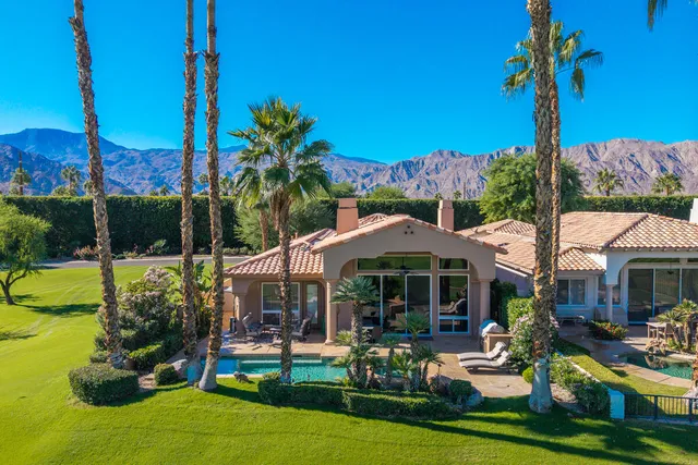 a view of a house with swimming pool and porch