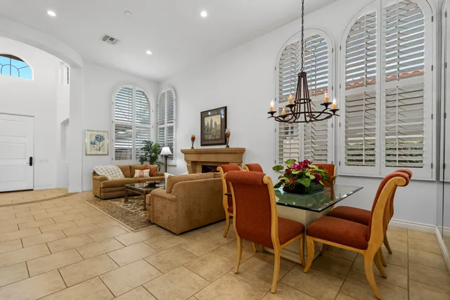 a living room with furniture a dining table and a fireplace