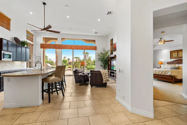 a very nice looking living room with a large window and stainless steel appliances