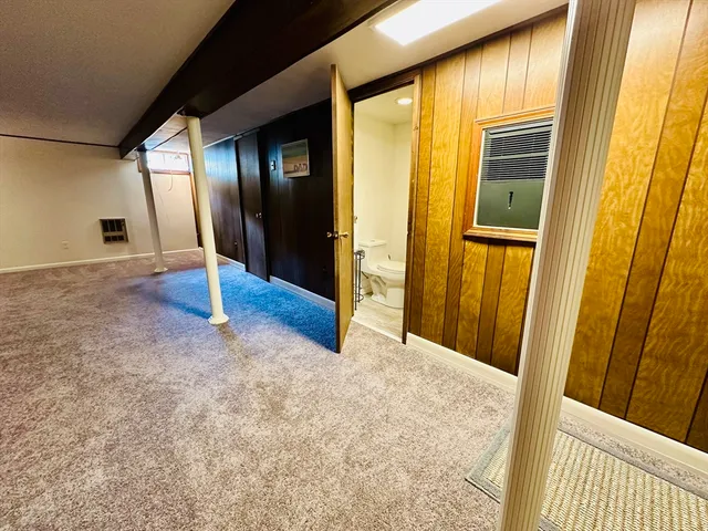 a white toilet sitting next to a white sink and vanity