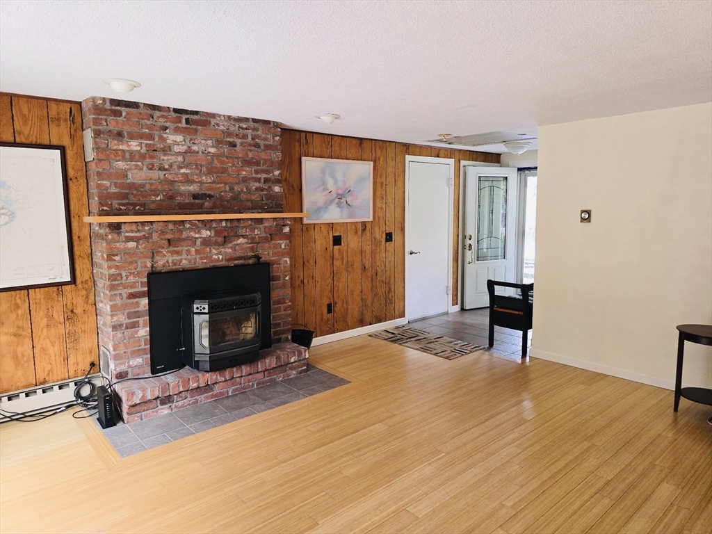 128 Sherwood Road Springfield, MA 01119 - Photo 24 of 39 a view of an empty room with wooden floor and a fireplace