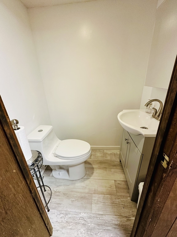 128 Sherwood Road Springfield, MA 01119 - Photo 31 of 39 a white toilet sitting next to a white sink and vanity