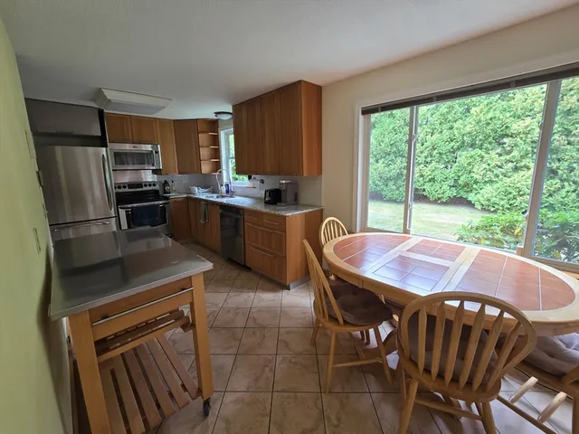 a view of kitchen with dining table and chairs