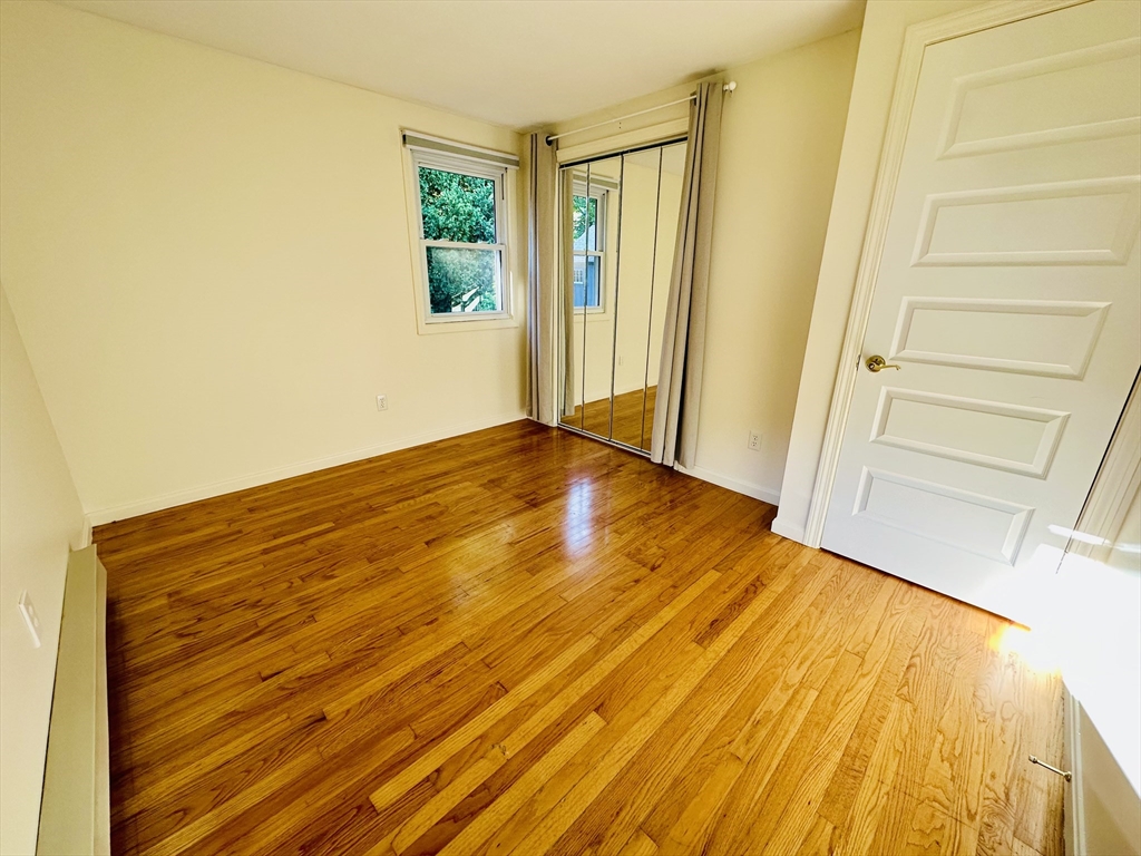 128 Sherwood Road Springfield, MA 01119 - Photo 9 of 39 a view of empty room with wooden floor and fan