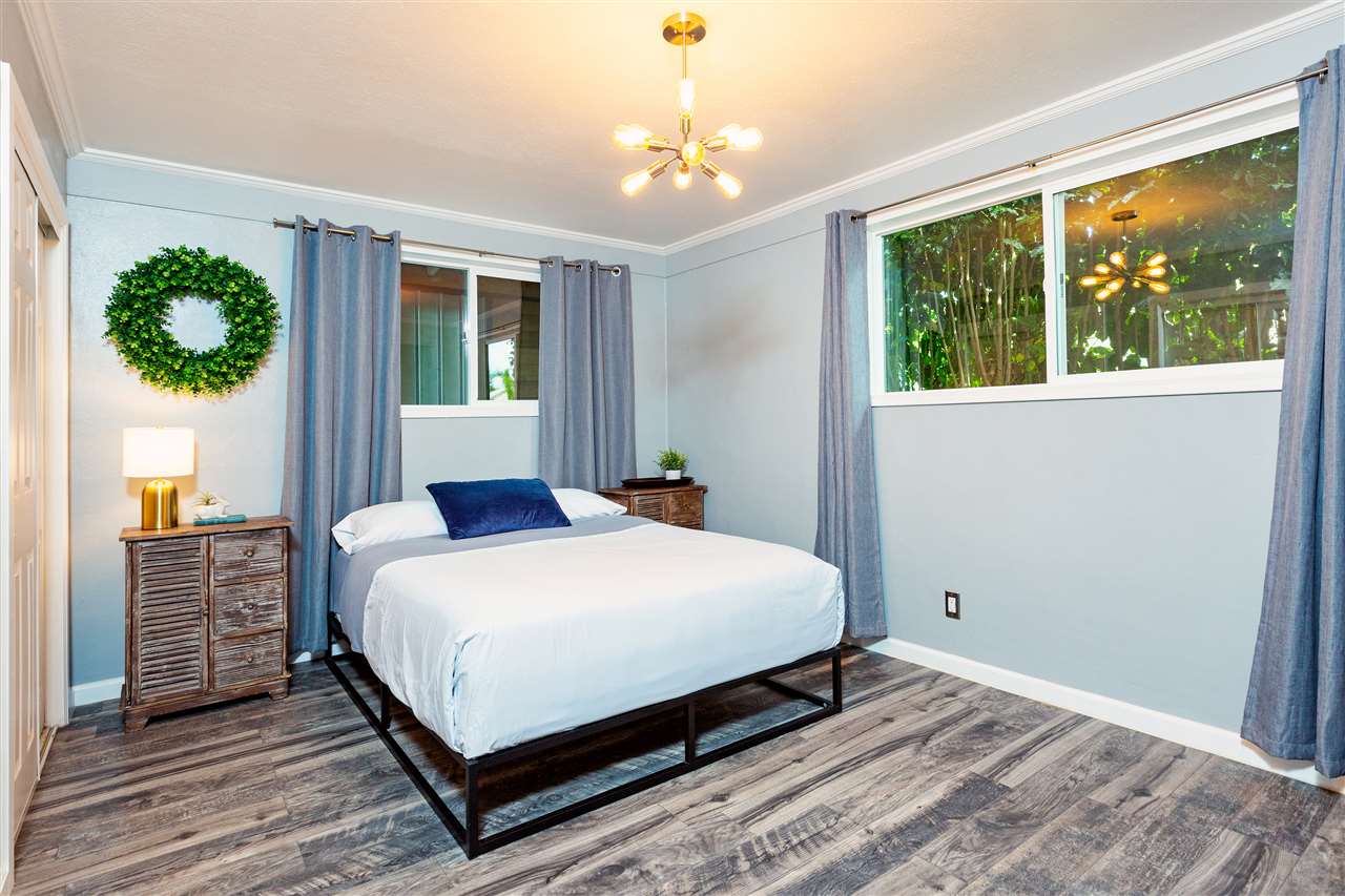 805 Kuulei Street Haiku, HI 96708 - Photo 13 of 28 a bedroom with a large bed and a window