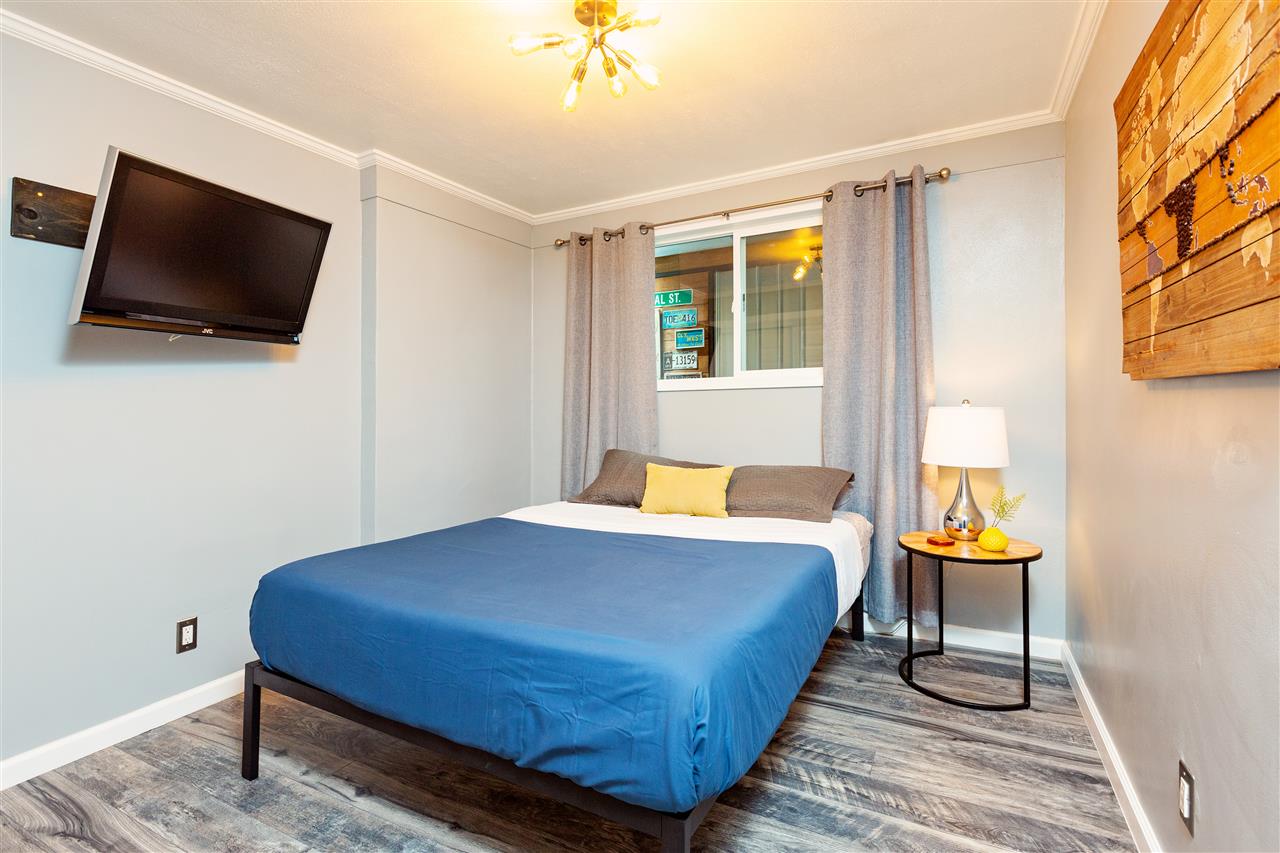 805 Kuulei Street Haiku, HI 96708 - Photo 14 of 28 a bedroom with a bed and flat screen tv