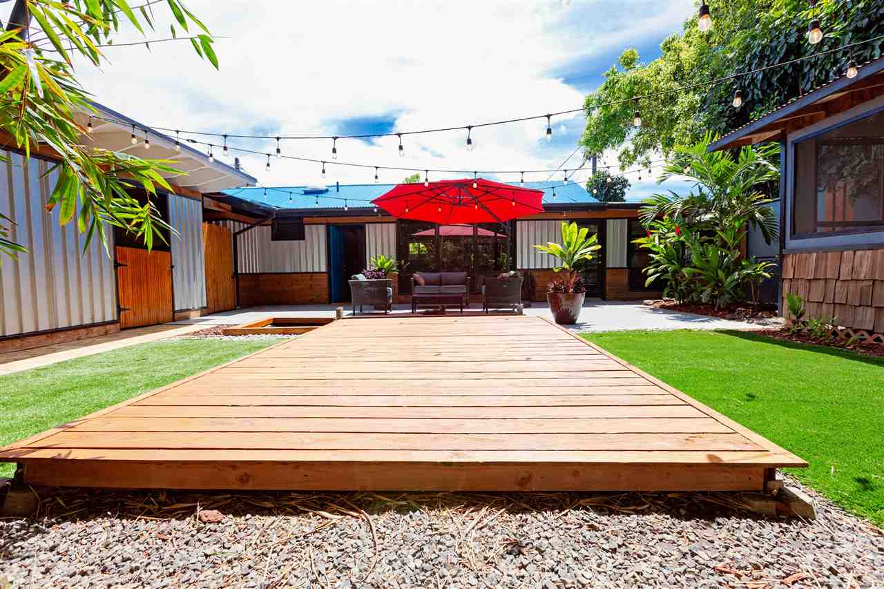 805 Kuulei Street Haiku, HI 96708 - Photo 18 of 28 a view of a patio with a table and chairs under an umbrella