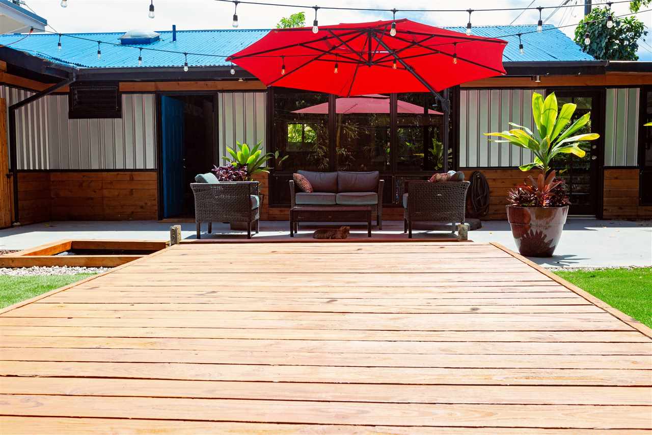 805 Kuulei Street Haiku, HI 96708 - Photo 2 of 28 a view of balcony with chairs and umbrella
