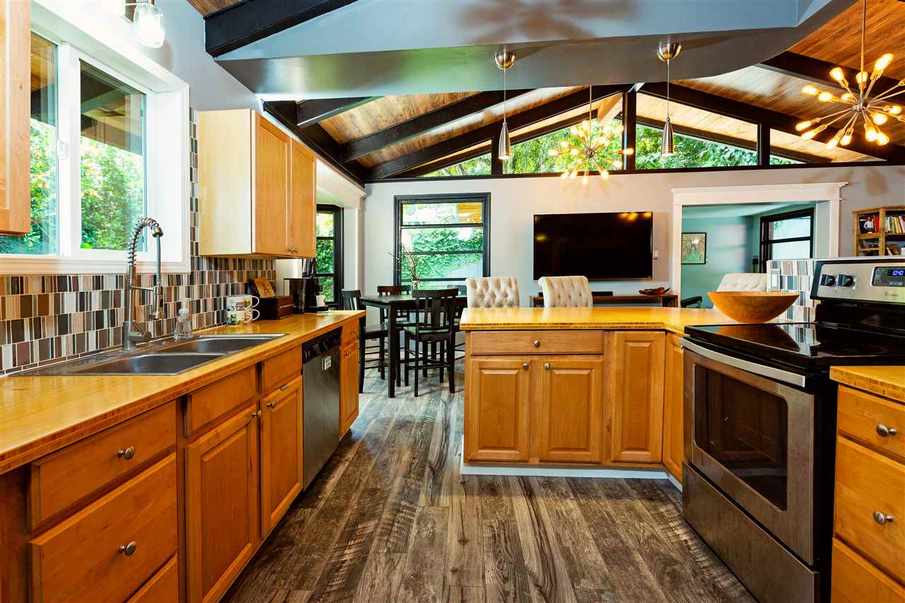 805 Kuulei Street Haiku, HI 96708 - Photo 4 of 28 a kitchen with stainless steel appliances granite countertop a stove a sink and a microwave
